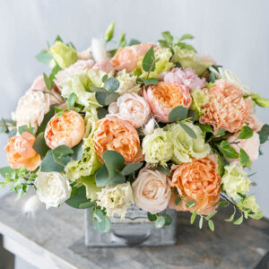 Bouquet of fresh spring flowers on gray wall background. Floral Bouquet of fresh spring flowers on gray wall background. Floral arrangement in vintage metal vase. flower shop, florist work.
